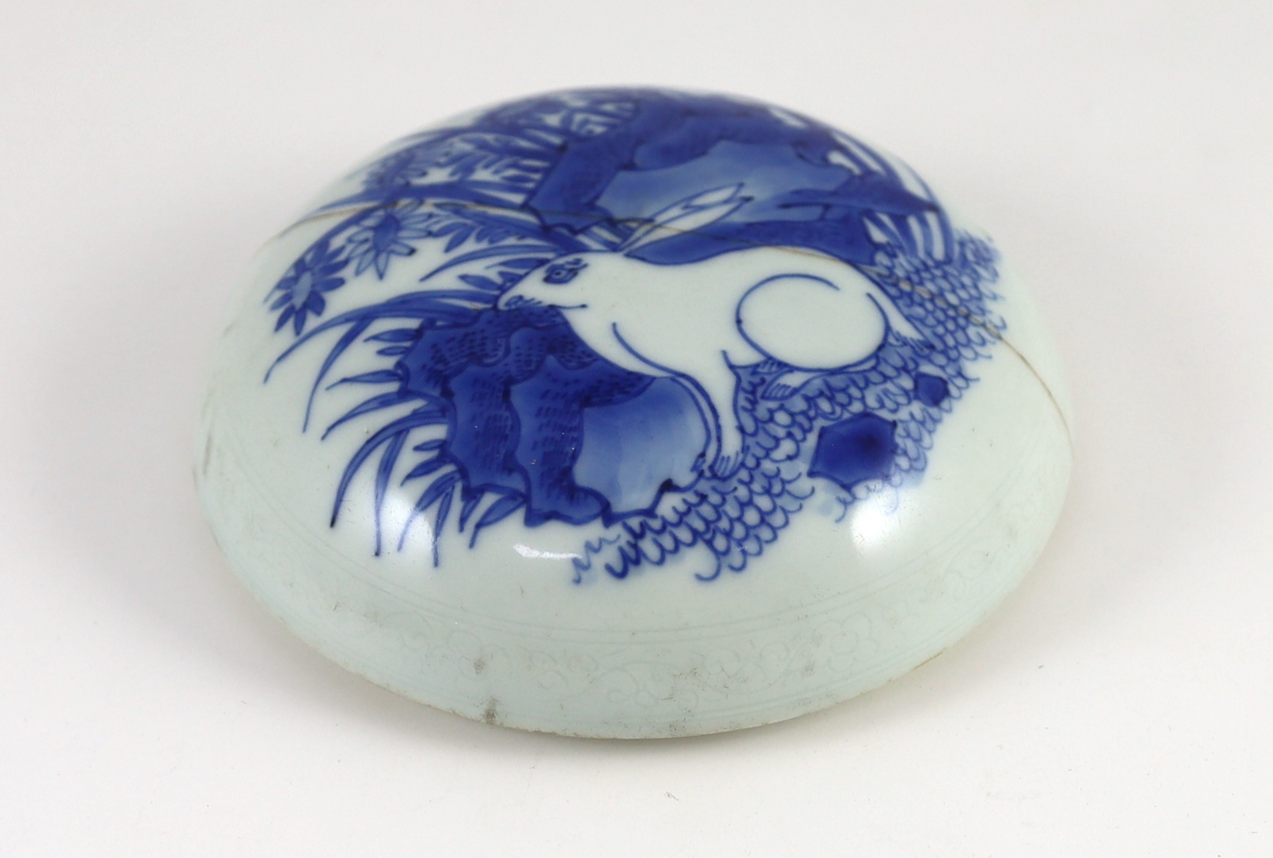 A Chinese Transitional blue and white ‘hare gazing at the moon’ cover, Chongzhen period (1627-1644), rivet repair